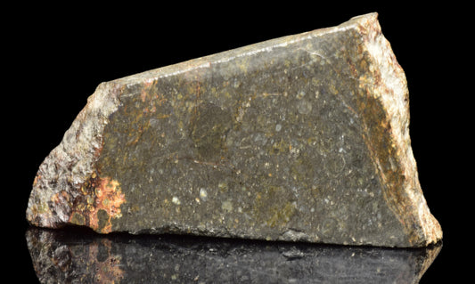 Close-up of a NWA 14224 LL3 meteorite slice weighing 4.47 grams, showing metallic and rocky textures.