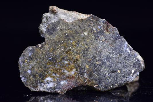 Slice of NWA 12344 Eucrite meteorite showing dark fusion crust and mineral matrix, offered by Buy Meteorite, LLC.