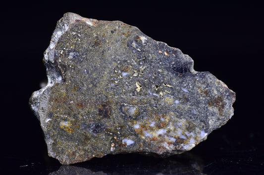 NWA 12344 Eucrite meteorite slice, 11.2 grams, showcasing dark, textured surface with mineral inclusions, from Buy Meteorite LLC.
