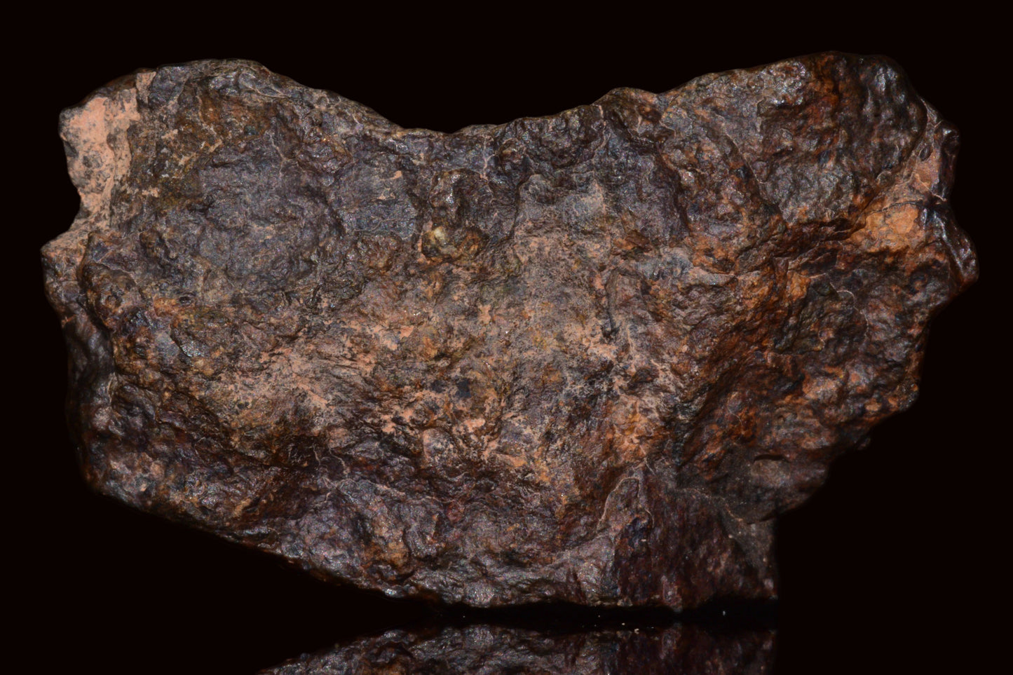 Natural fragment of NWA 13272 ungrouped achondrite meteorite, showing its rocky surface and natural mineral textures.
