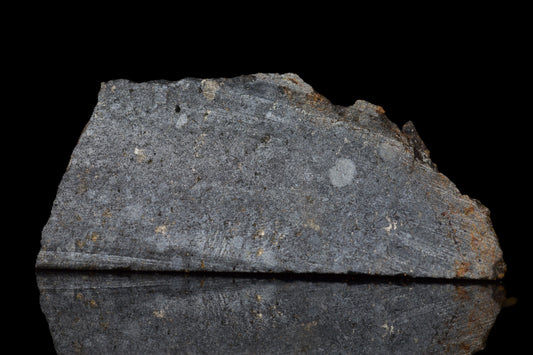 NWA 14224 LL3 meteorite slice weighing 2.90 grams, showing dark fusion crust and metallic mineral interior.