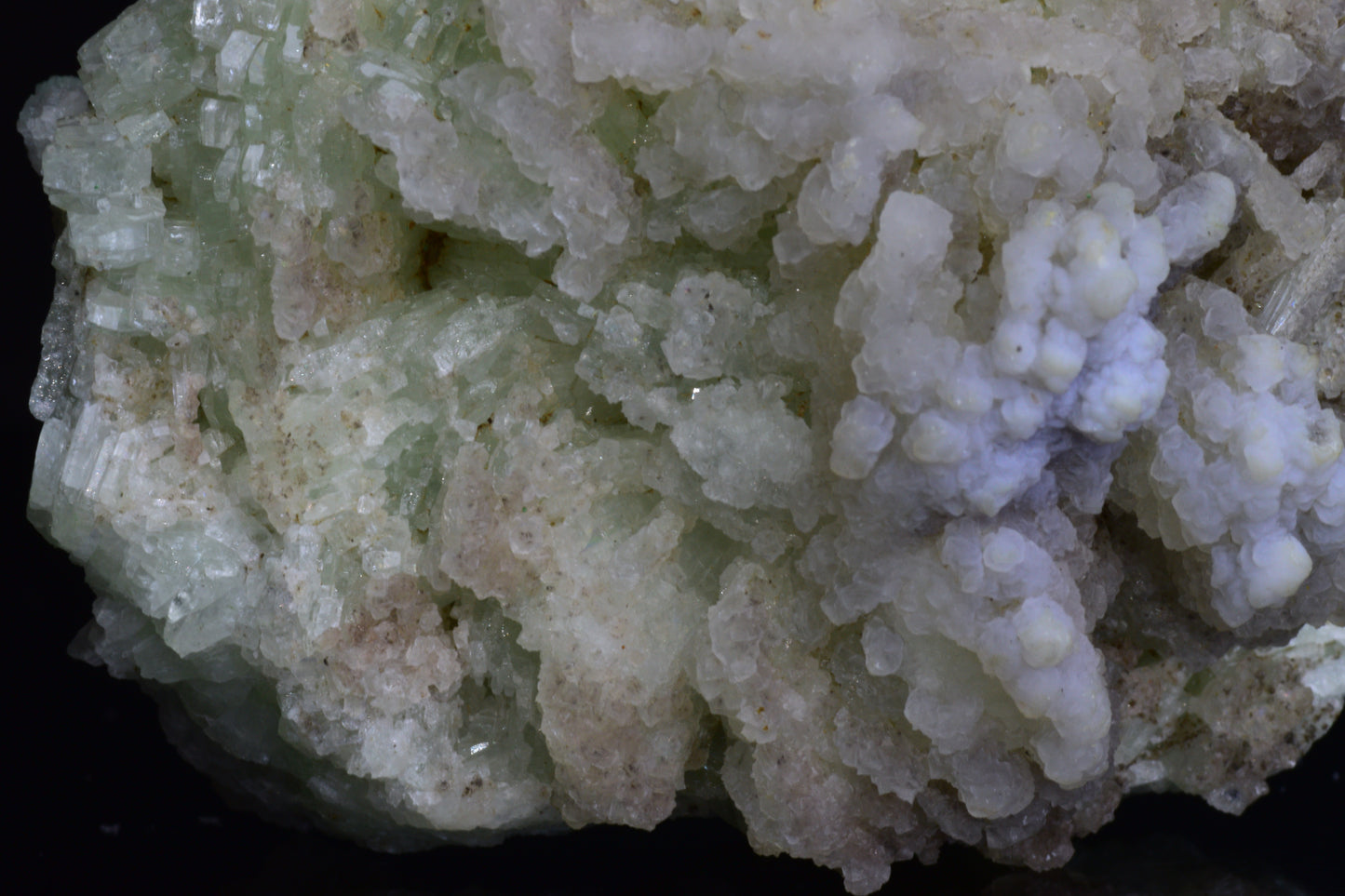 Prehnite crystal from Imilchil, Morocco showcasing smooth, green mineral with natural crystal formations and a polished surface.