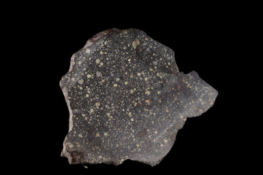 Close-up of the NWA 12858 R3 meteorite, a 19.2g specimen with a rugged, dark surface showing unique mineral textures.