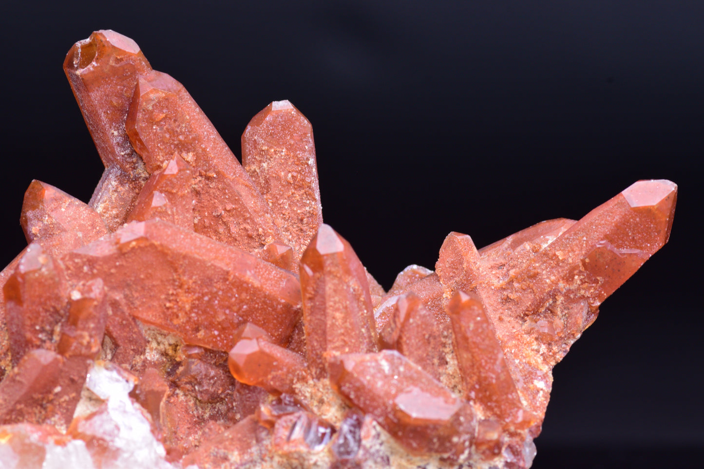 Large red quartz crystal cluster with ferruginous inclusions from Tinejdad, Morocco, showcasing vibrant mineral formations.