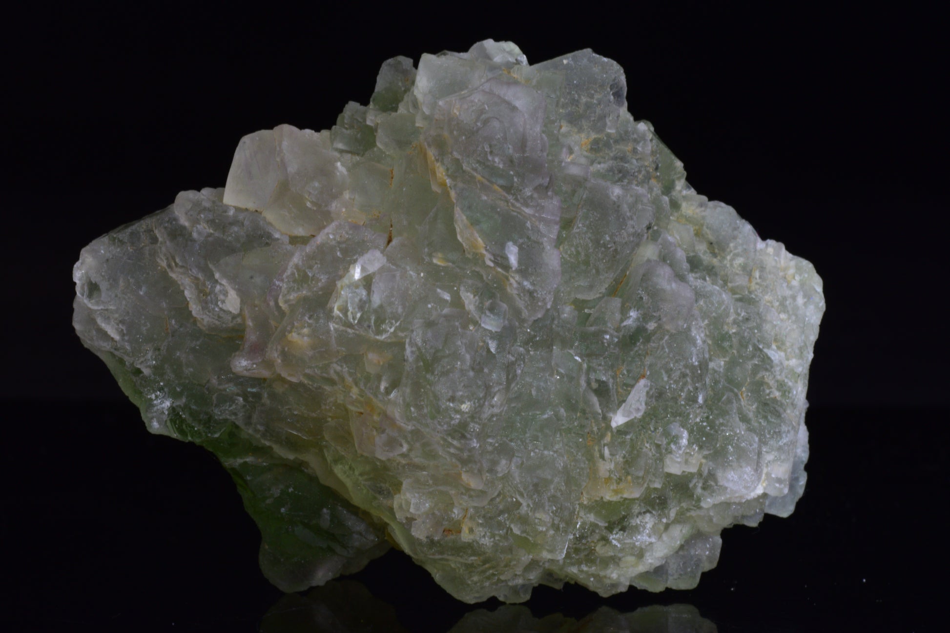 Green fluorite crystal from El Hammam, Morocco, with vibrant green hues, displayed on a neutral background.