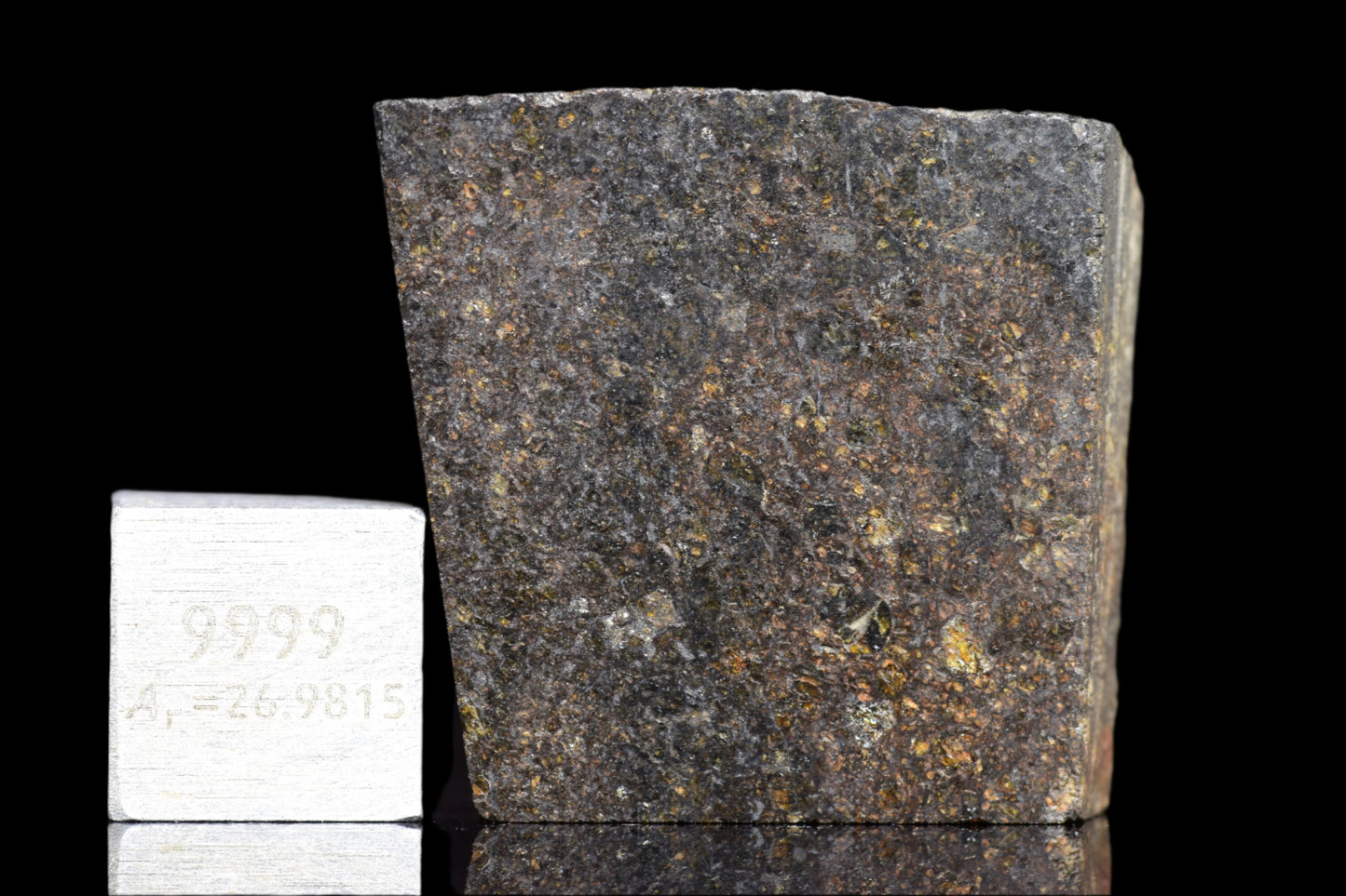 NWA 11757 ureilite meteorite fragment from Buy Meteorite, LLC, showing dark, rocky surface with metallic inclusions.