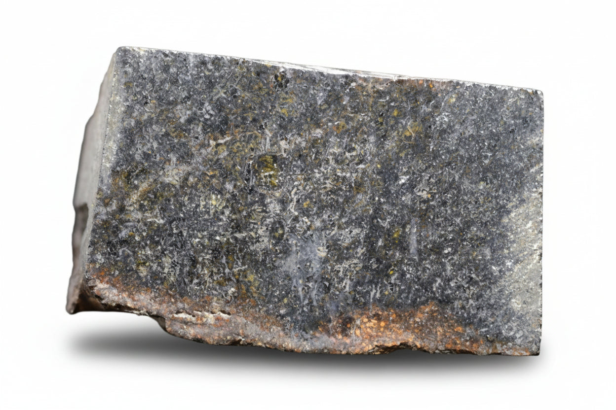 NWA 11757 Ureilite meteorite fragment weighing 7.6 grams, showcasing its dark, rocky surface and mineral-rich interior.