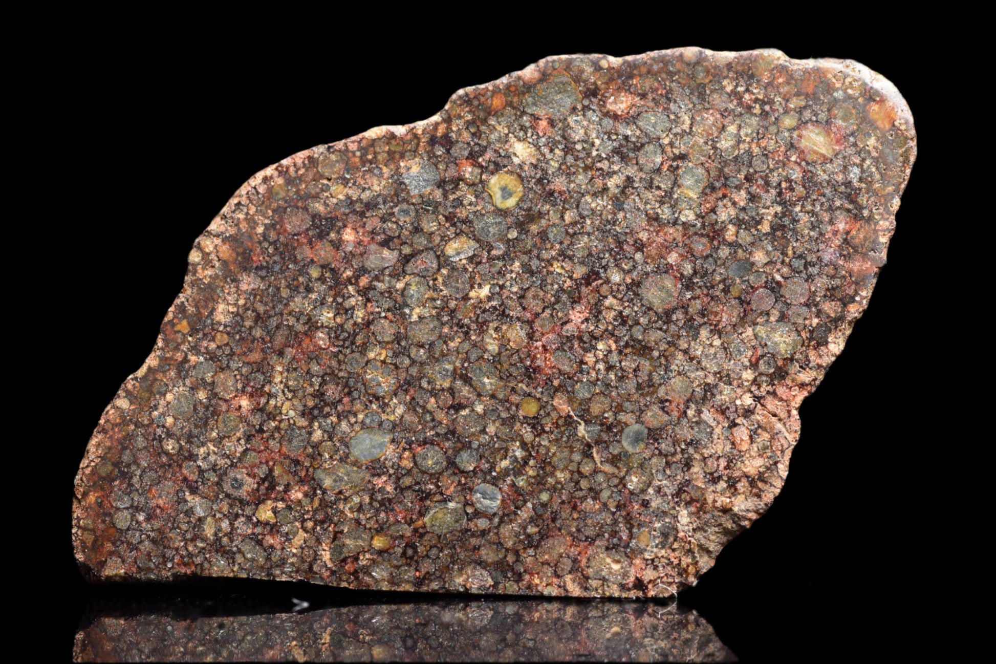 Close-up of NWA 12341 L3 meteorite, a 3.7g chondrite sample with rugged, dark surface and mineral inclusions.