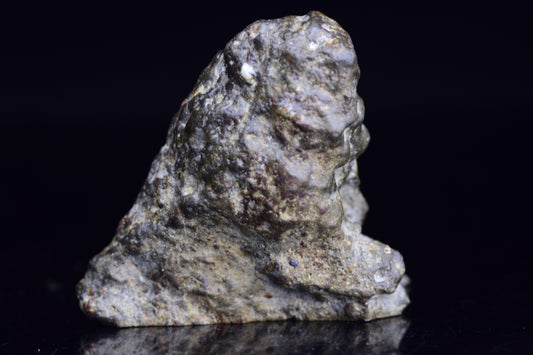 NWA 12344 Eucrite meteorite endcut showing dark, textured surface and mineral details, from Buy Meteorite, LLC.