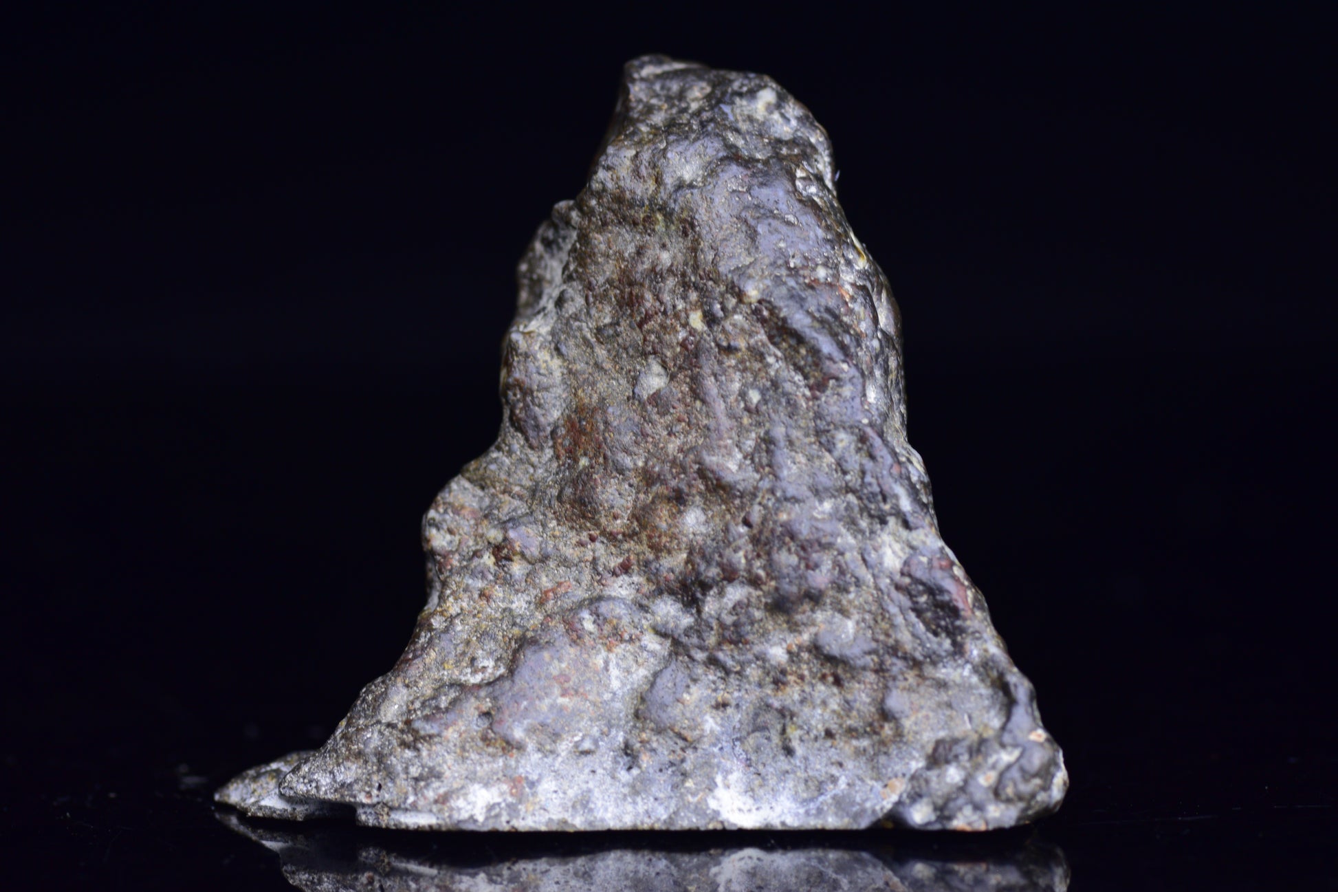 NWA 12344 Eucrite meteorite endcut showing dark mineral-rich surface with rough edges, sold by Buy Meteorite, LLC.