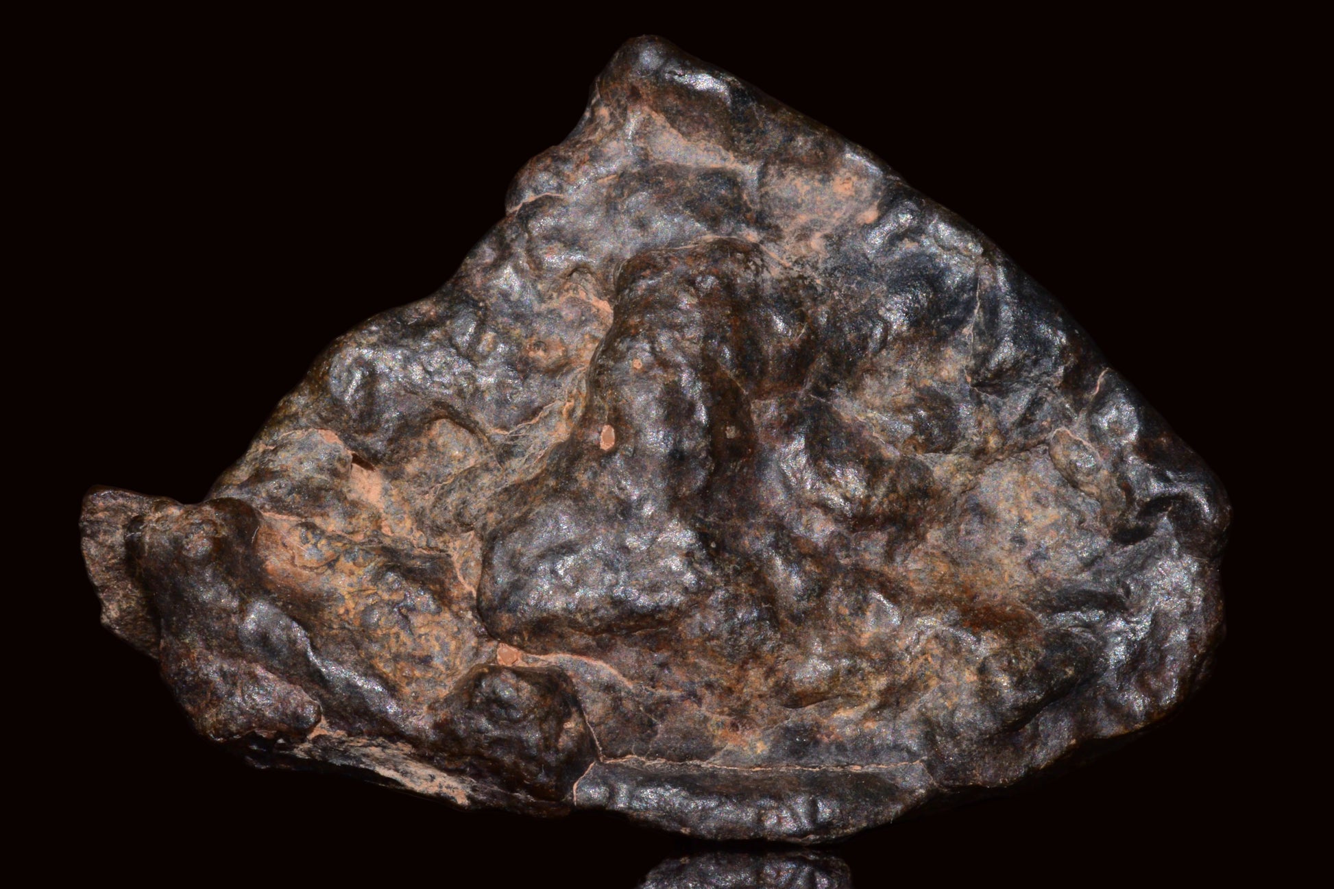 Natural fragment of NWA 13272 ungrouped achondrite meteorite, 17.7g, showing dark surface and mineral textures.
