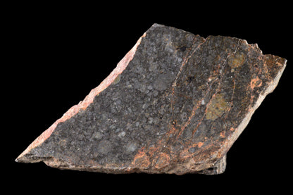 NWA 14224 LL3 meteorite slice, 2.14 grams, showing dark fusion crust and metallic interior, from Buy Meteorite, LLC.