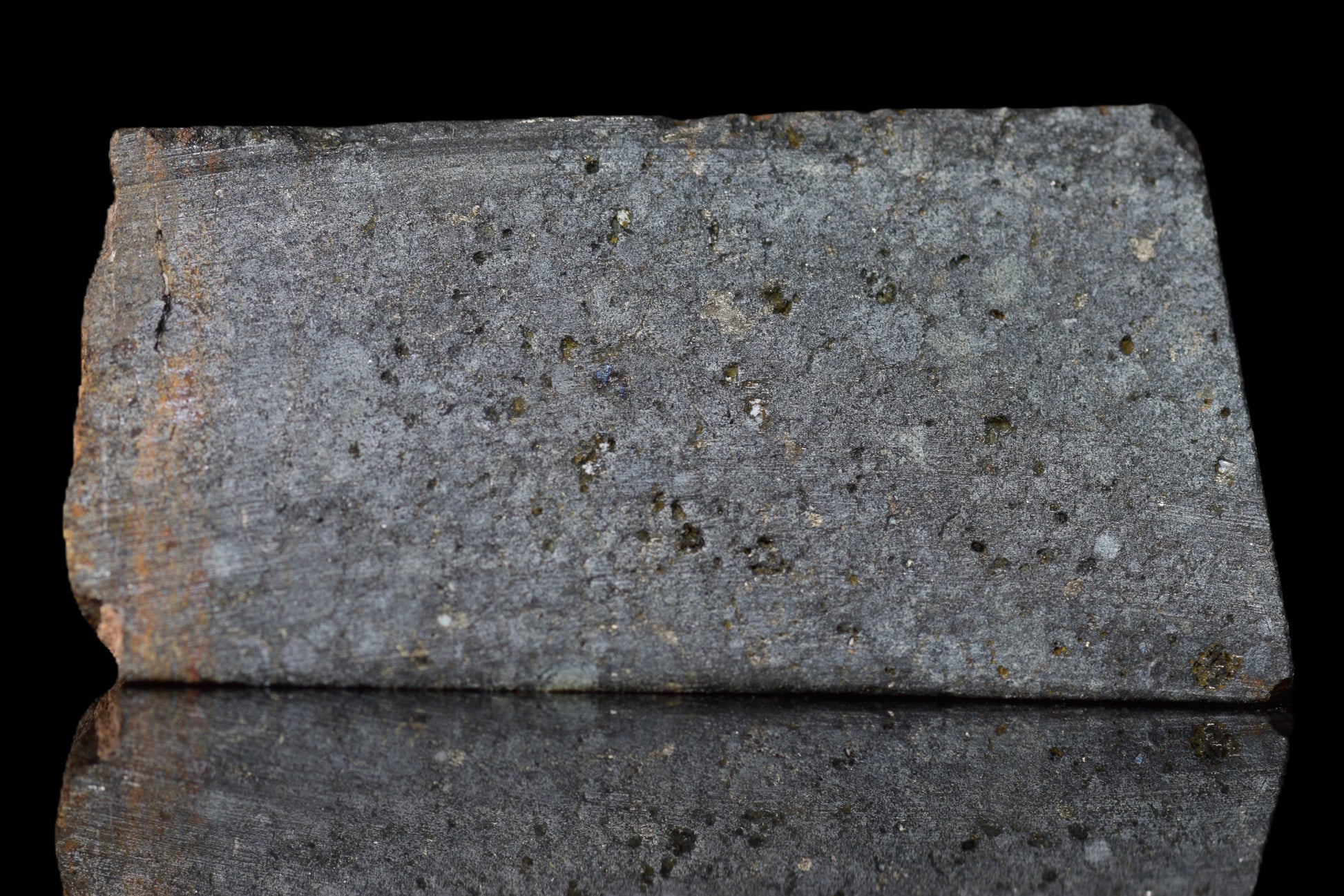 NWA 14224 LL3 meteorite slice weighing 3.36 grams, showing metallic and crusted surface details.