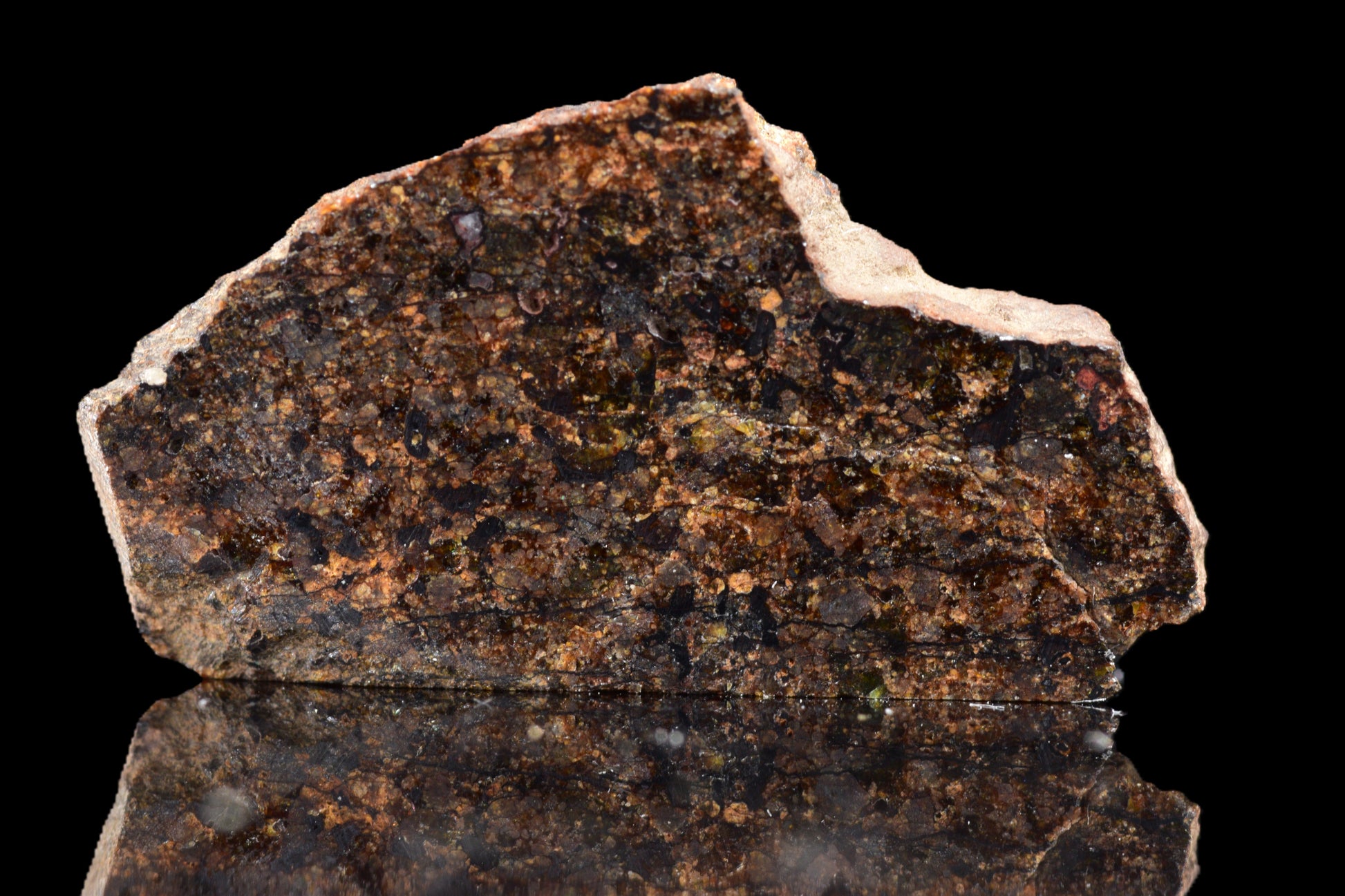 NWA 14234 H7 meteorite specimen weighing 1.29 grams, showcasing its dark, textured surface with unique mineral features.