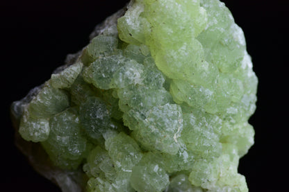 Prehnite and actinolite crystal from Boulemane, Morocco, showcasing green mineral formations in a natural mineral specimen.