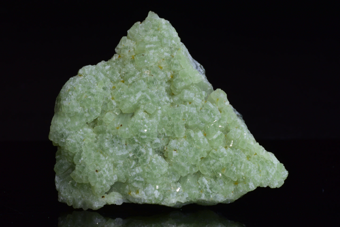 Crystals of prehnite and actinolite from Boulemane, Morocco, showcasing green and gray mineral formations.
