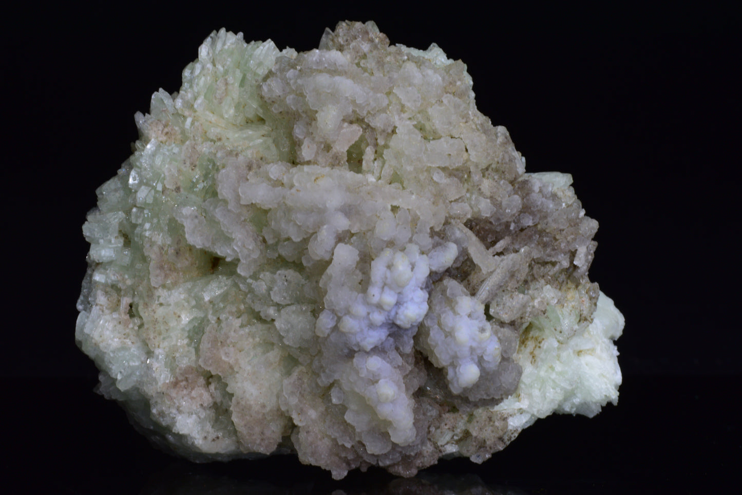 Prehnite crystal from Imilchil, Morocco, showing smooth green mineral with natural mineral formations and a polished surface.