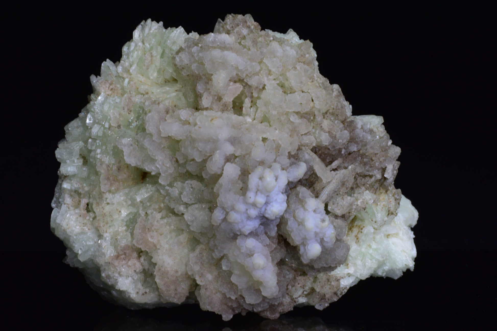Prehnite crystal from Imilchil, Morocco, showing smooth green mineral with natural mineral formations and a polished surface.