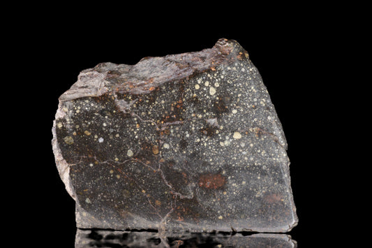 Close-up of the NWA 12858 R3 meteorite, a 46.3g specimen with rough, dark exterior and unique meteorite surface details.