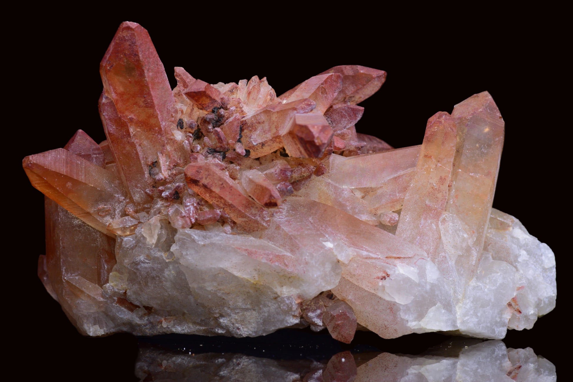 Large red quartz crystal cluster with ferruginous inclusions from Tinejdad, Morocco, showcasing vibrant mineral formations.
