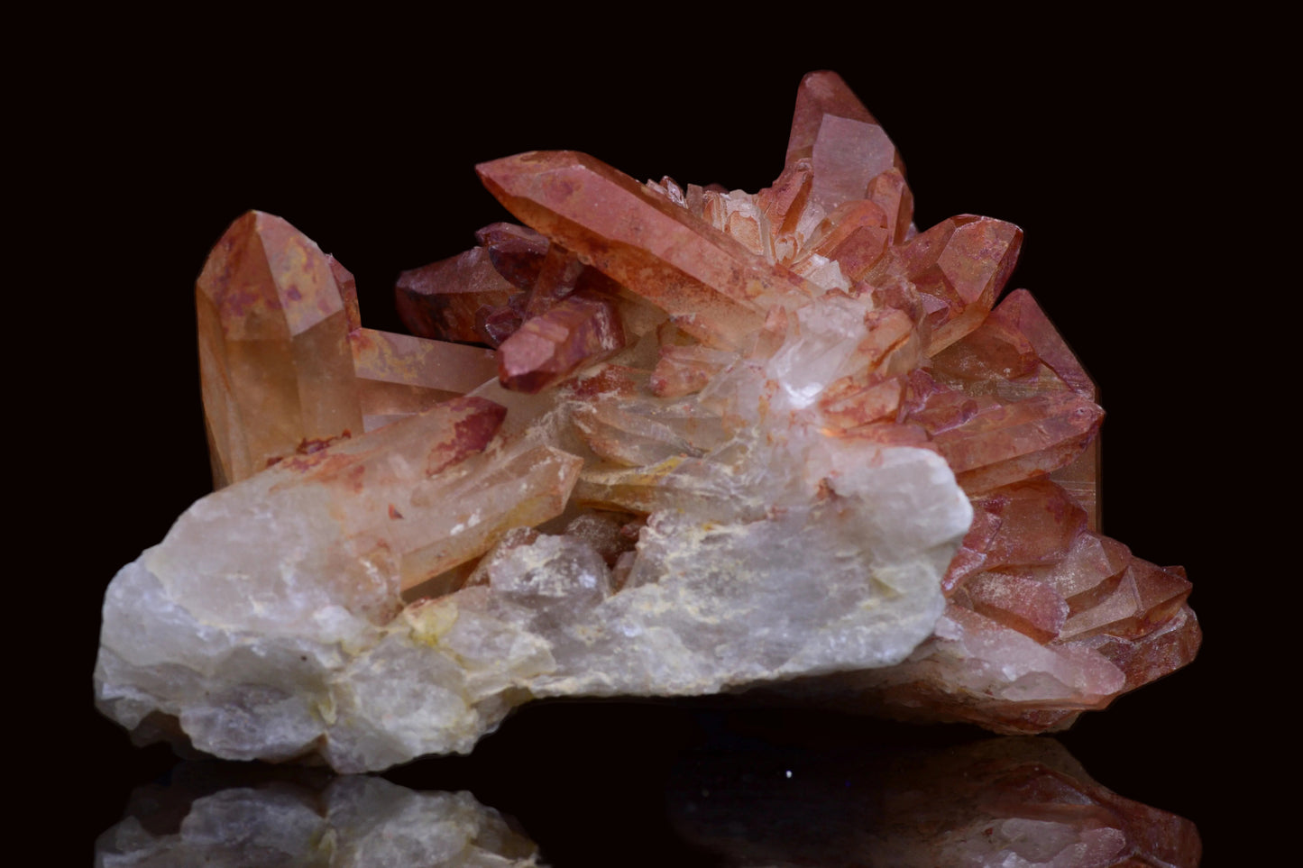 Large red quartz crystal cluster with ferruginous inclusions from Tinejdad, Morocco, showcasing vibrant red and iron-rich mineral formations.