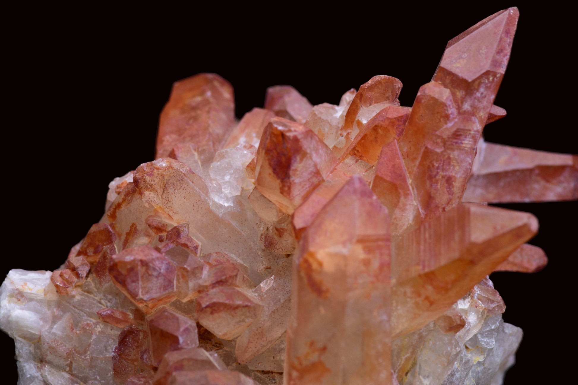 Large red quartz crystal cluster with ferruginous deposits from Tinejdad, Morocco, showcasing vibrant mineral-rich quartz formation.