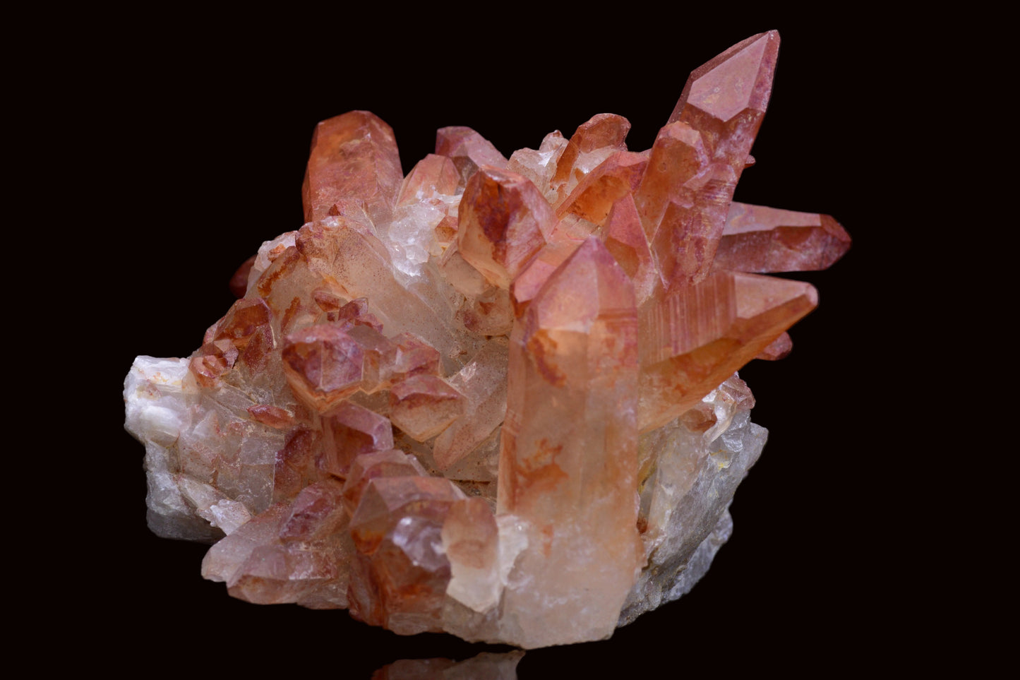 Large red quartz crystal cluster with ferruginous inclusions from Tinejdad, Morocco, showcasing vibrant mineral formations.
