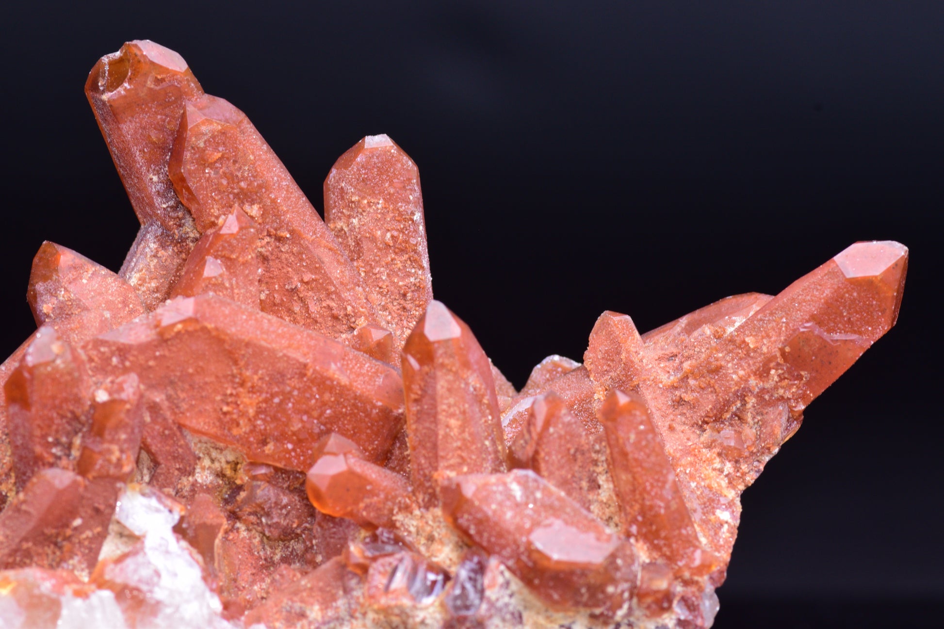 Large red quartz crystal cluster with ferruginous inclusions from Tinejdad, Morocco, showcasing vibrant mineral formations.