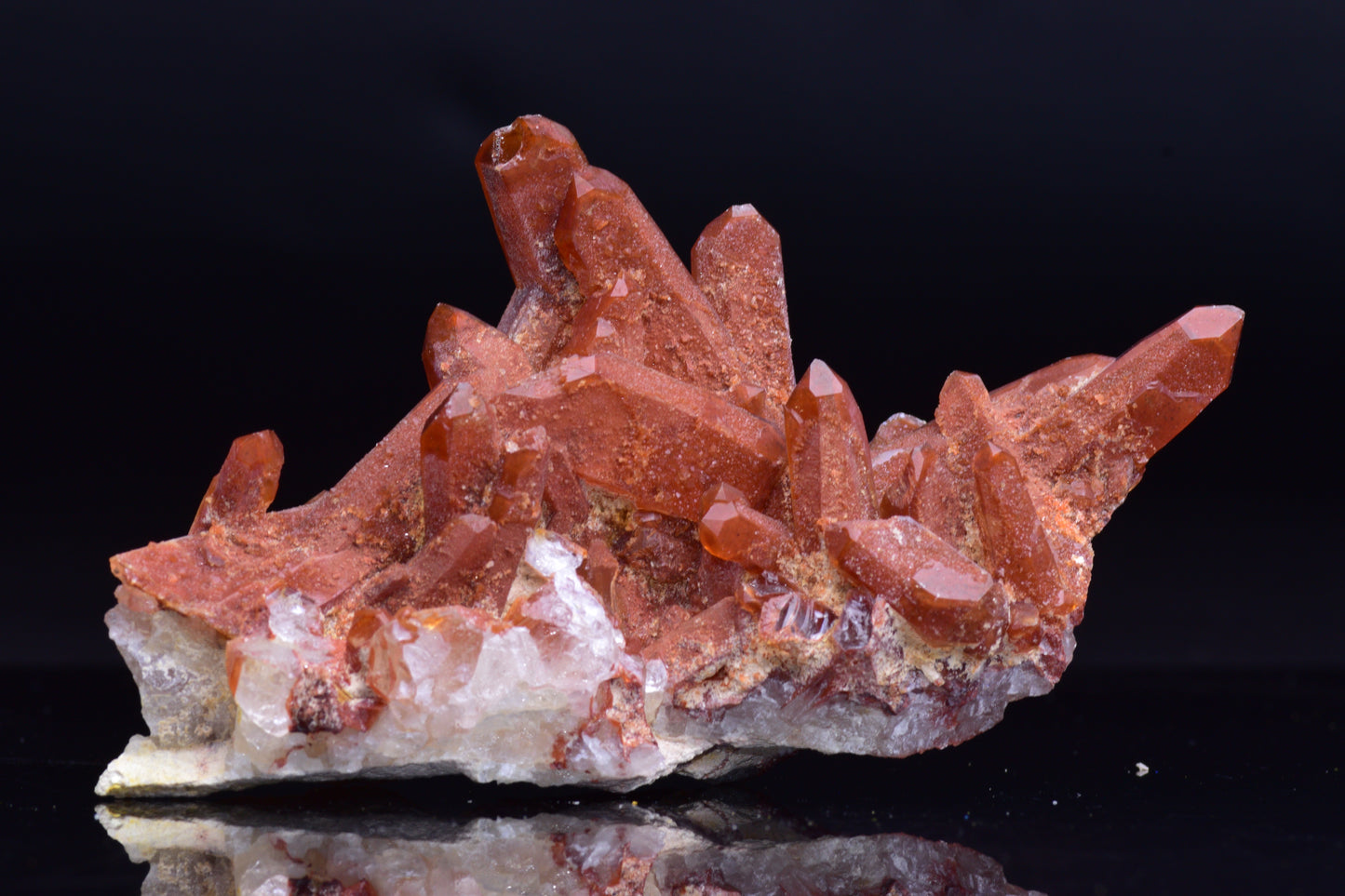 Large red quartz crystal cluster with ferruginous inclusions from Tinejdad, Morocco, showcasing vibrant mineral formations.