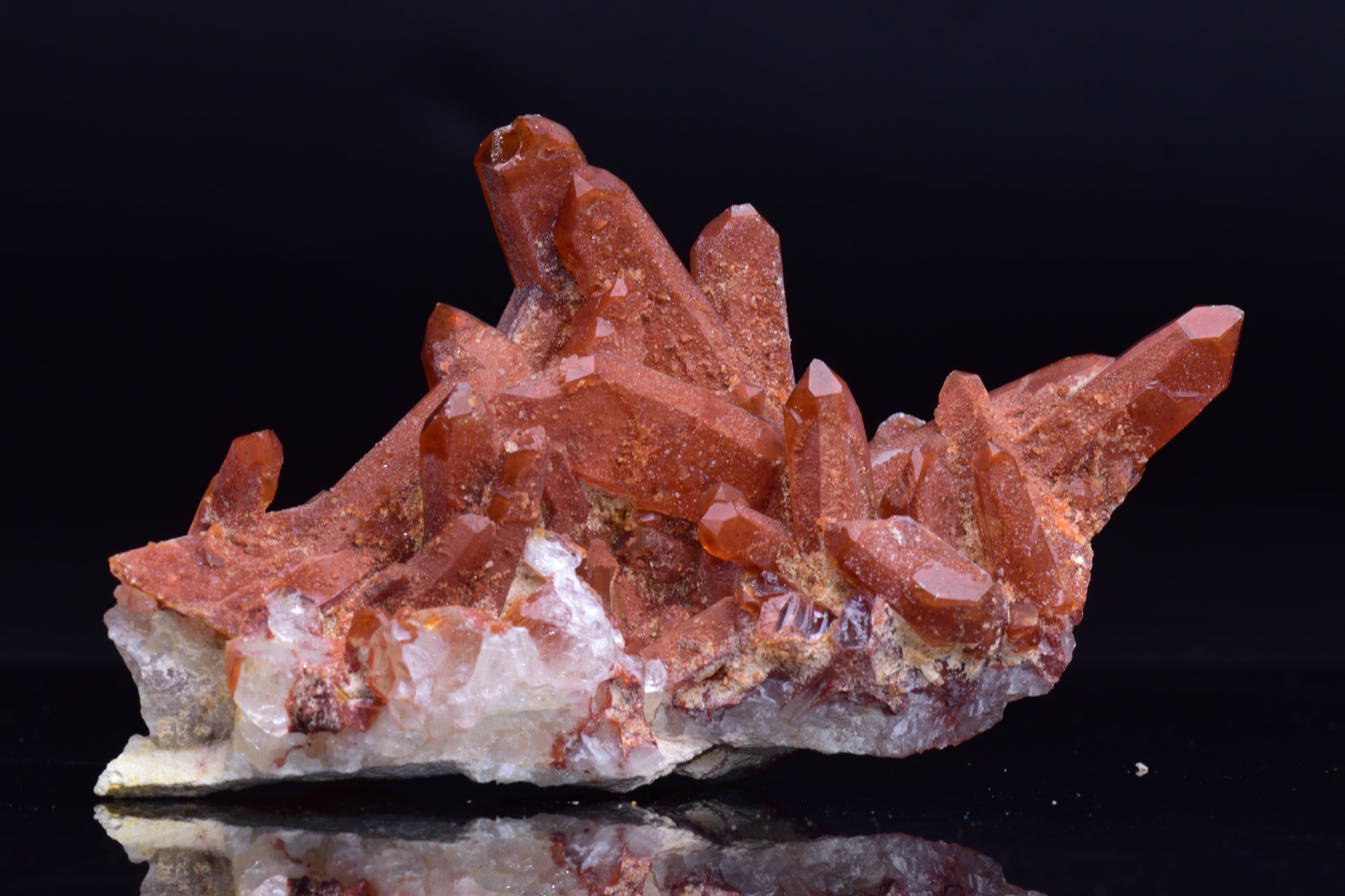 Large red quartz crystal cluster with ferruginous inclusions from Tinejdad, Morocco, showcasing vibrant mineral formations.