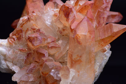 Large red quartz crystal cluster with ferruginous inclusions from Tinejdad, Morocco, showcasing vibrant red and earthy mineral tones.
