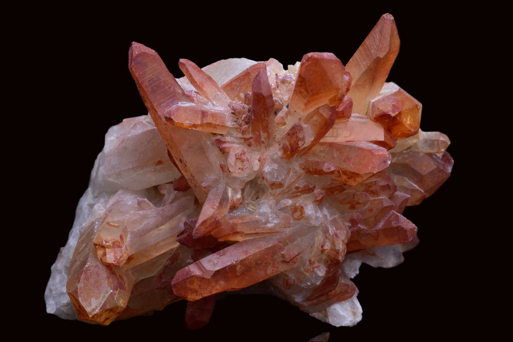 Large red quartz crystal cluster with ferruginous inclusions from Morocco, featuring vibrant red and metallic mineral details.
