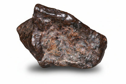 Complete natural fragment of NWA 13272 ungrouped achondrite meteorite, 10.5g, showing rough, dark surface with mineral textures.