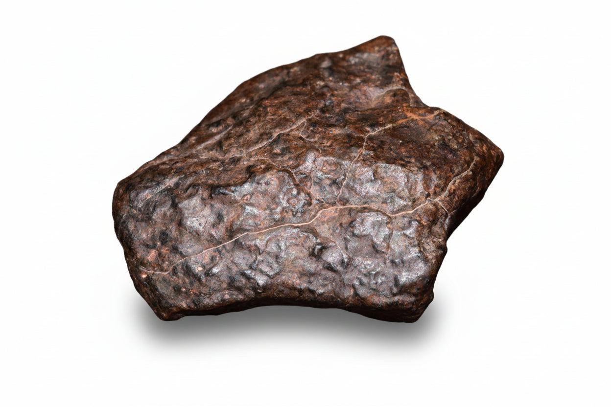 Complete natural fragment of NWA 13272 ungrouped achondrite meteorite, 10.5g, with rough surface and mineral details visible.
