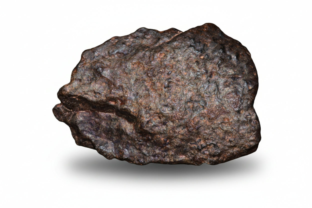 Natural fragment of NWA 13272 ungrouped achondrite meteorite, 10.8g, showing its dark, rocky surface and mineral texture.