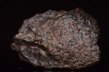 Natural fragment of NWA 13272 ungrouped meteorite, complete 10.8 g piece showing its unique surface and mineral texture.